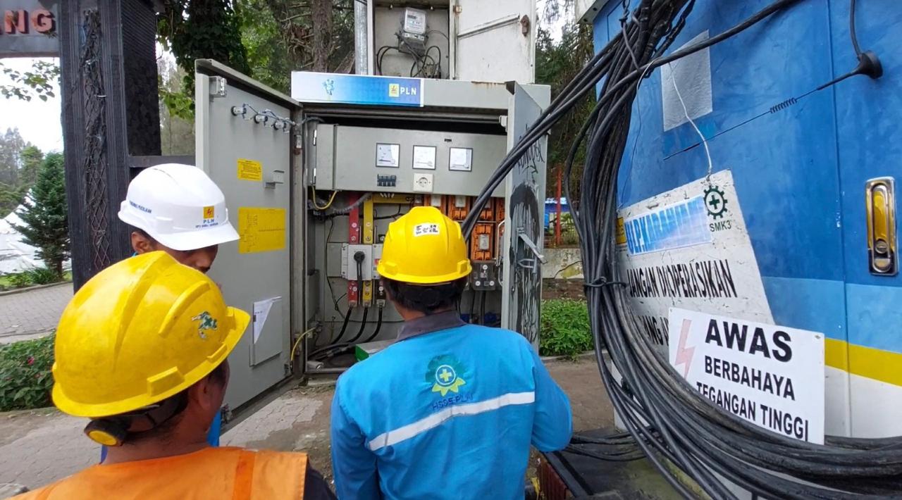 Petugas pelayanan teknik PLN UP3 Bukit Barisan sedang melakukan pemasangan genset di Taman Mejuah-juah guna mendukung dan mensukseskan pelaksanaan festival bunga dan buah di Kabupaten Karo.